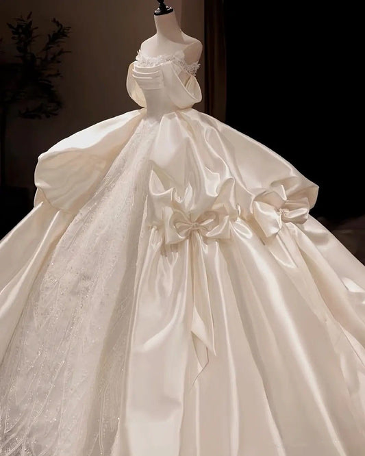 Regal Ivory Off Shoulder Satin & Beaded Lace Ball Gown Wedding Dress With Dramatic Satin Bow And Cathedral Train AE116