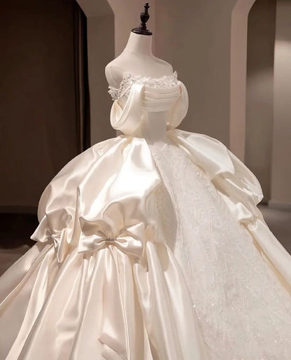 Regal Ivory Off Shoulder Satin & Beaded Lace Ball Gown Wedding Dress With Dramatic Satin Bow And Cathedral Train AE116