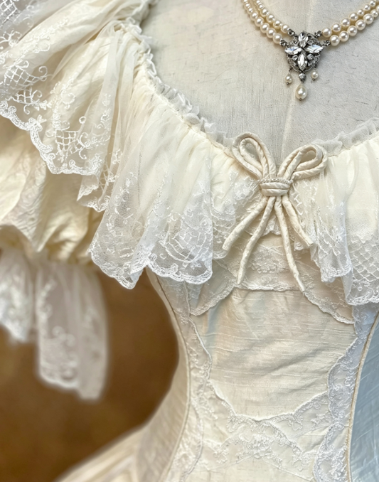 Glam Vintage Ivory Off Shoulder Puffed Short Sleeve Lace Ruffle Neckline Tiny Bow Embellished Satin Corset Ballgown Wedding Dress AE142